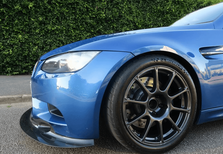 Close view of a blue BMW M3 wheel